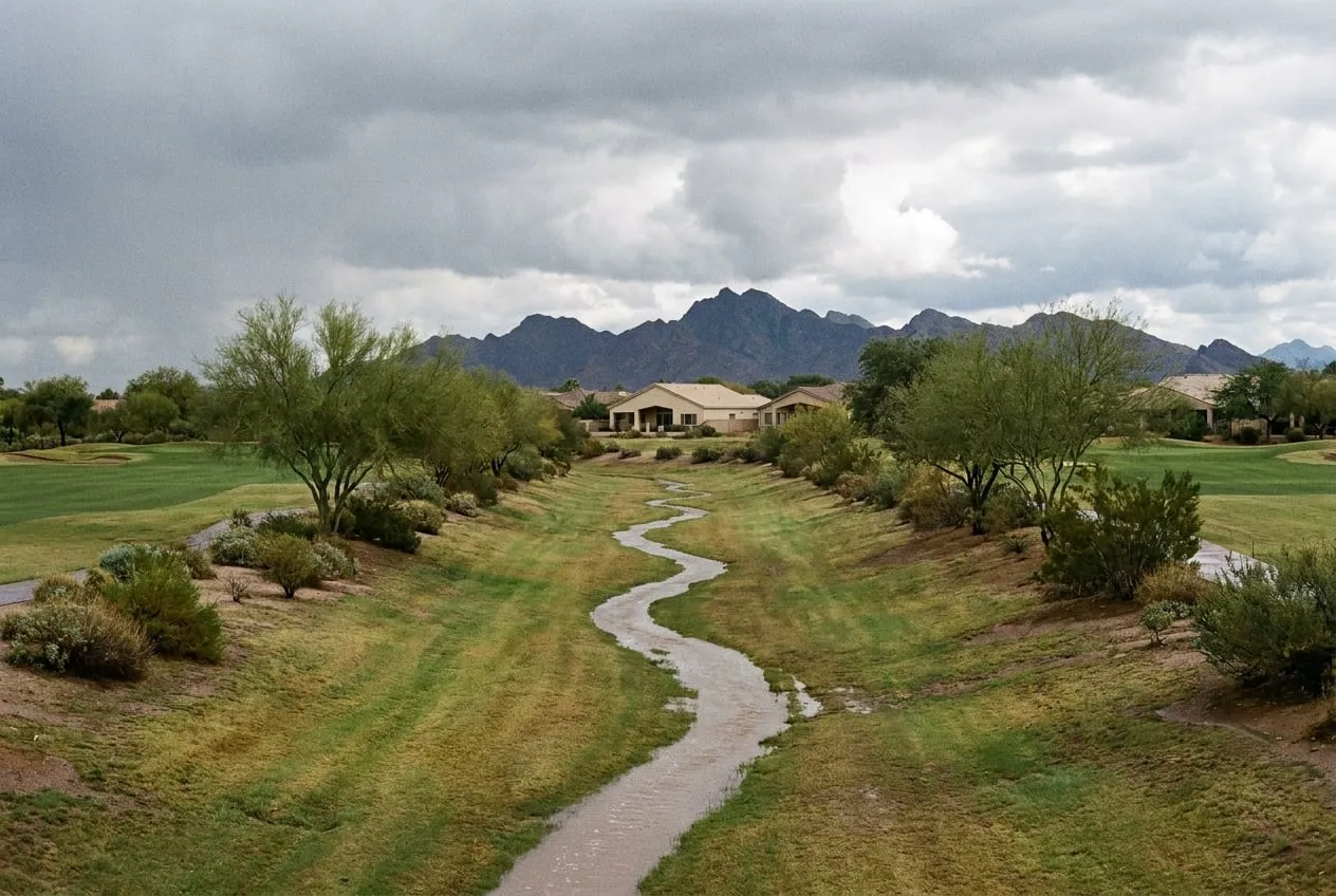 Storm runoff moves along the grass-lined Indian Bend Wash channel where it crosses a golf course in northeast Phoenix.